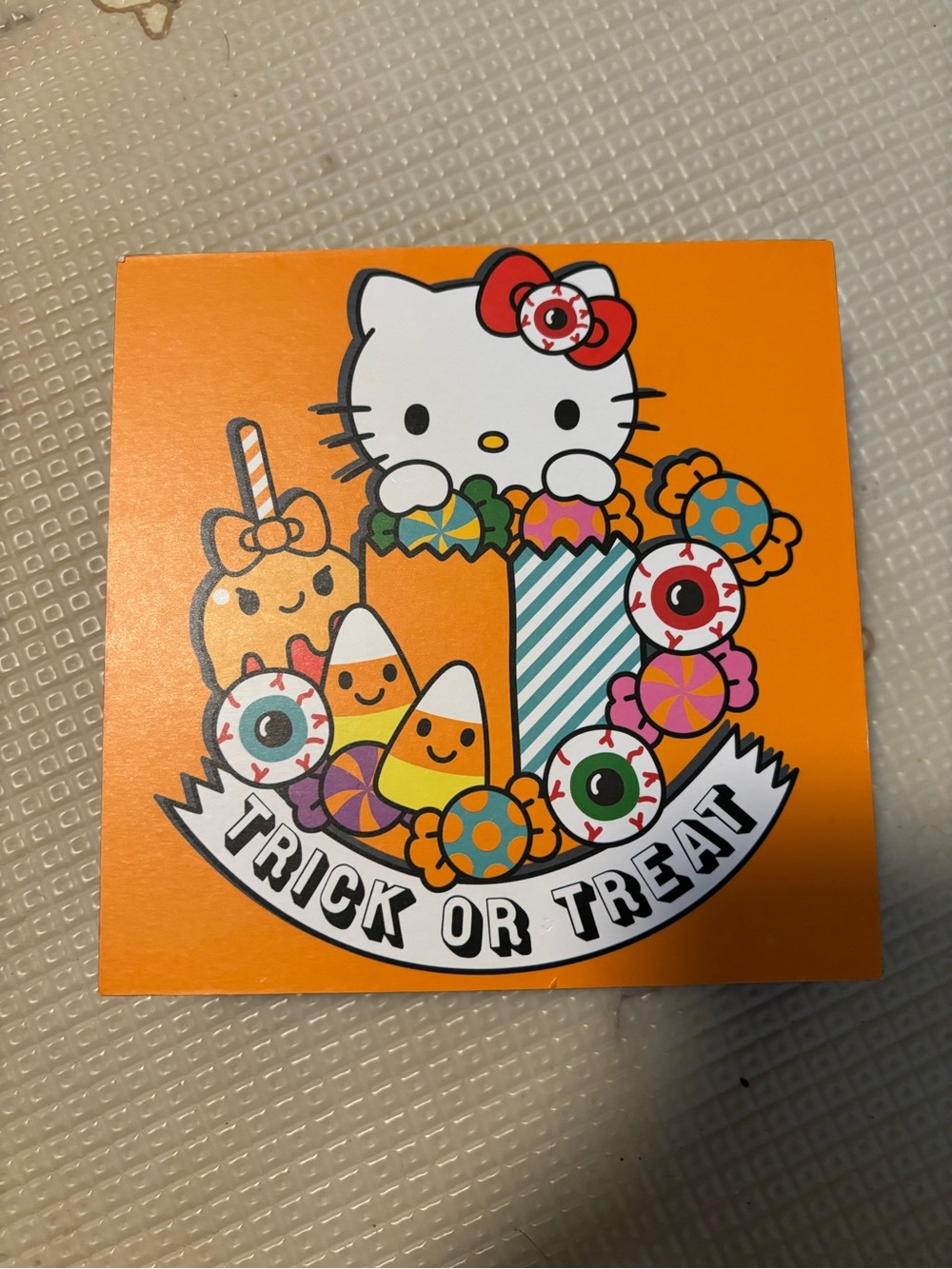 Hello Kitty Orange Halloween Trick or Treat Sign with Multicolor Candy